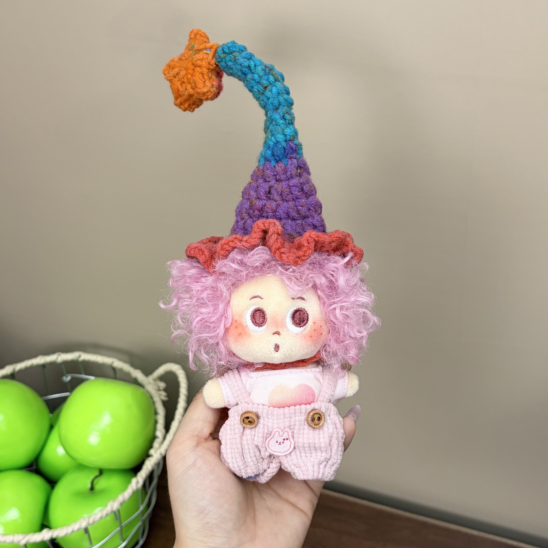 Supplied product photograph: lilac curly-haired doll with a star-topped pointed hat. Style reference 1; outfit and hat details vary.