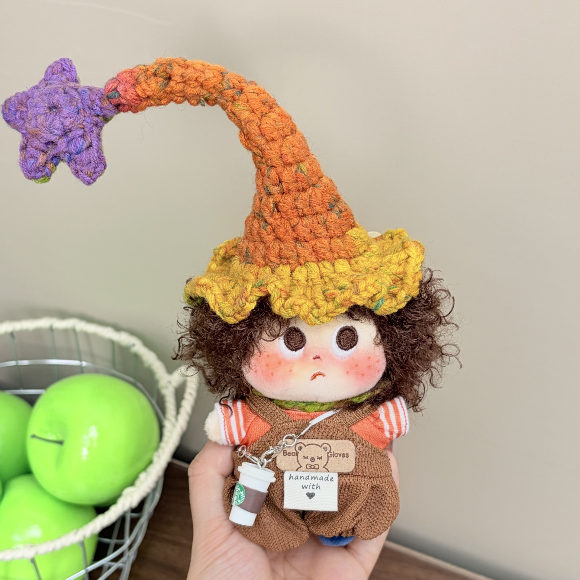 Supplied product photograph: brunette curly-haired doll with a star-topped pointed hat. Style reference 2; outfit and hat details vary.